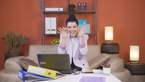 Home-office-worker-young-woman-making-cute-gesture-at-camera.